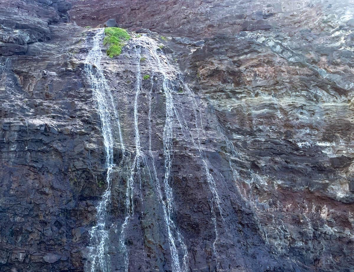 A waterfall along the Na Pali Coast of Kauai, Hawaii