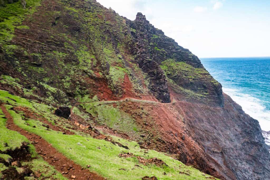 Narrow section of the Kalalau Trail in Kauai, HI, featuring dropoffs